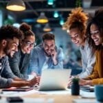 Diverse team collaborating with technology in a bright workspace.