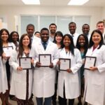Amanchukwu Lab team celebrating with awards in lab.