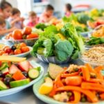 Children enjoying healthy school meals in a bright setting.