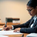 Person creating a resume for NGO career advancement.