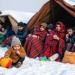 Gazan families in makeshift shelters during harsh winter.
