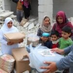 Humanitarian workers assisting families in Gaza relief efforts.