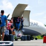 Australians boarding a RAAF plane during evacuation.
