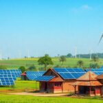 Solar panels and wind turbines in a rural Indian landscape.