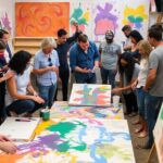 Artists collaborating in a colorful studio setting.