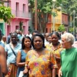 People in Mozambique discussing in a lively street setting.