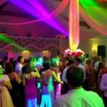 Attendees dancing at the festive Maypole Ball event.
