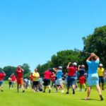 Golfers playing on a sunny day at a golf tournament.