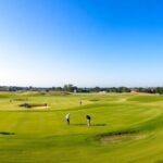 Golf tournament scene with players and spectators on course.