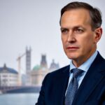 Friedrich Merz in suit discussing European cooperation.