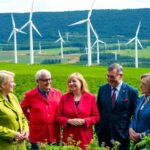 Swedish officials discussing climate action in a green landscape.
