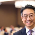 Masato Kanda smiling in a formal setting at ADB