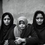 Kashmiri Pandit family in exile, evoking sadness and resilience.