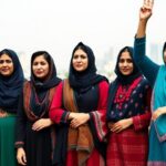 Diverse Afghan women standing together in solidarity.