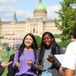 Students discussing democratic governance in front of Parliament Hill.