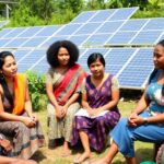 Group discussion on renewable energy and gender justice outdoors.