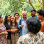 Diverse people collaborating outdoors in a green setting.
