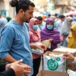 UNRWA staff delivering aid in a busy Gaza setting.