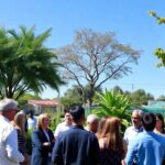Community leaders discussing sustainable development outdoors.