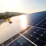 Solar panels in Zimbabwean landscape with local community.