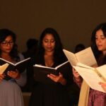 Five diverse poets reading at an intimate event.