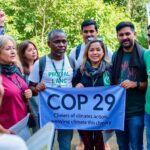 Activists discussing climate issues after COP29 outdoors.