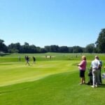 Golfers enjoying a sunny day at a golf tournament.