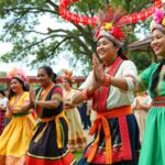 Dancers in traditional attire celebrating cultural heritage outdoors.
