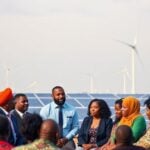 Diverse leaders meet to discuss renewable energy solutions.