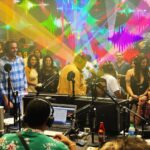 Diverse group in a lively radio studio discussion.
