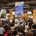 Diverse attendees discussing renewable energy at a conference.