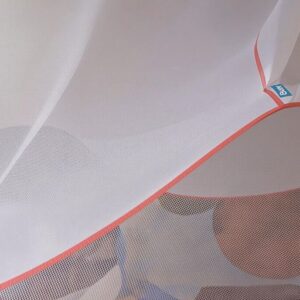 A dual-insecticide mosquito net over a bed.
