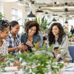 Diverse women collaborating in a bright, open workspace.