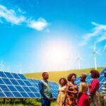 Solar panels and wind turbines in an African landscape.