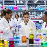Diverse women scientists collaborating in a modern laboratory.