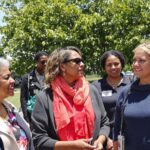 Diverse women leaders engaged in conversation about climate action.