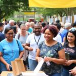 Diverse people engaging in a community event outdoors.