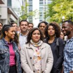 Diverse group expressing mixed emotions about gender equality.