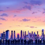 City skyline at dusk with diverse people discussing.