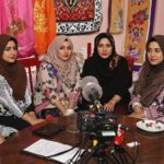 Afghan women collaborating in a media setting.