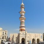 Reconstructed Al-Hadba Minaret in Mosul against blue sky.