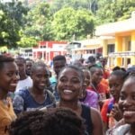 Haitian youth engaged in community activities with smiles.