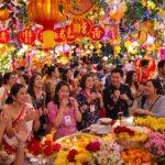 Diverse people celebrating New Year with colorful decorations.