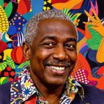 Portrait of Frankétienne with Haitian art background.