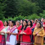 Women marching in traditional attire on Ts’msyen territory.