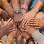 Diverse individuals united in solidarity against human trafficking.