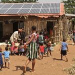 African community thriving with solar energy and joyful families.