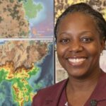 Professor Faith Karanja with geospatial maps and data.