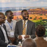Diverse professionals discussing energy solutions in Africa.