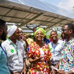 Diverse professionals discussing renewable energy innovations in Africa.